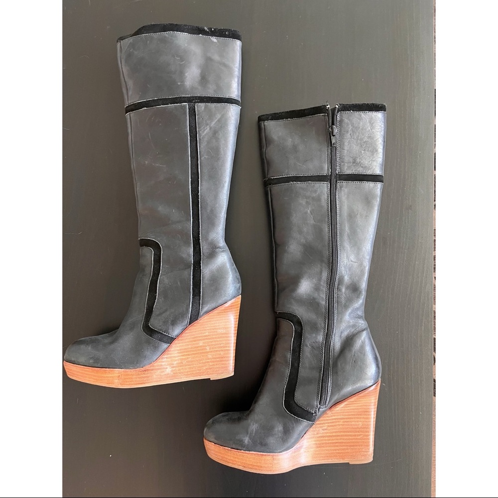Black leather knee high boots.